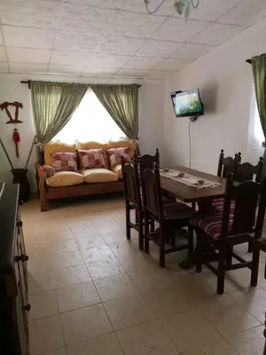 a living room with a table and a couch at mi casita en tanti, casa 25 in Tanti