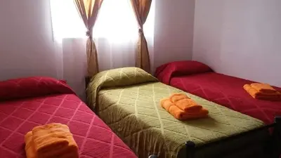 two twin beds in a room with a window at mi casita en tanti, casa 25 in Tanti