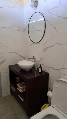 a bathroom with a sink and a mirror on a counter at Cabañas Chirivita Atos Pampa in Atos Pampa