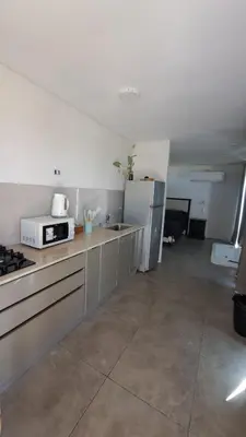 a kitchen with a stove and a refrigerator at Cabañas Chirivita Atos Pampa in Atos Pampa