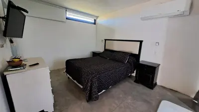 a bedroom with a bed and a television in it at Cabañas Chirivita Atos Pampa in Atos Pampa