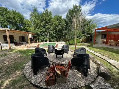 a group of chairs sitting around a fire pit at Aires- Casas de campo in Villa Carlos Paz