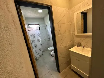 a bathroom with a shower and a sink and a toilet at Aires- Casas de campo in Villa Carlos Paz