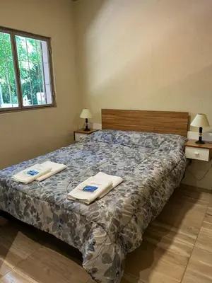 a bedroom with a bed with two towels on it at El Atardecer in Trapiche