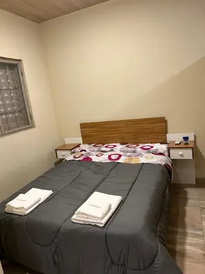 a bedroom with a bed with two towels on it at El Atardecer in Trapiche