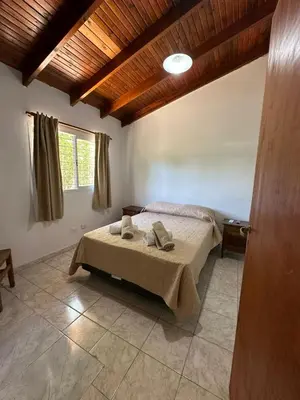 a bedroom with a bed with two towels on it at La Casa de Aromas del Valle in Santa Rosa de Calamuchita