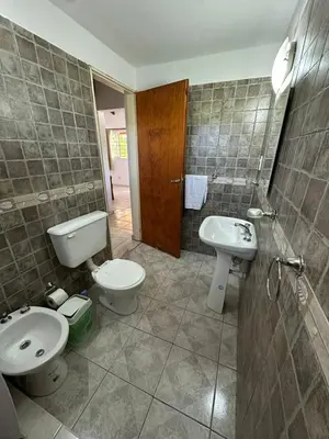 a bathroom with a toilet and a bidet and a sink at La Casa de Aromas del Valle in Santa Rosa de Calamuchita