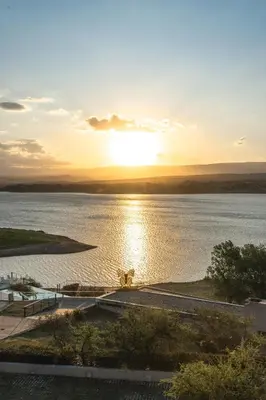 a sunset over a large body of water at PUEBLO CHICO - casas de lago in Villa Ciudad de America