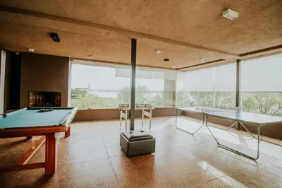 a living room with a pool table and a fireplace at PUEBLO CHICO - casas de lago in Villa Ciudad de America