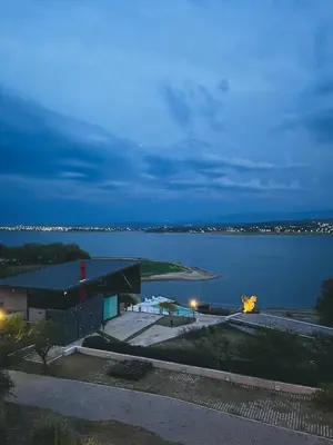 a building on the shore of a lake at night at PUEBLO CHICO - casas de lago in Villa Ciudad de America