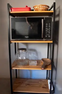 a microwave on a shelf with a cat in it at Departamento Córdoba Centro in Cordoba