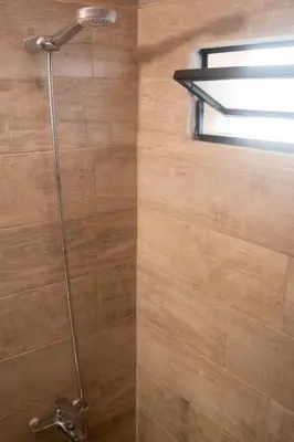 a shower in a bathroom with a window at Departamento Córdoba Centro in Cordoba