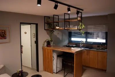 a kitchen with a wooden counter and a desk at Departamento Córdoba Centro in Cordoba