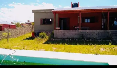 a small house with a yard and a pool at Alquilo casa totalmente equipada con pileta y vista a las Sierras in Tanti