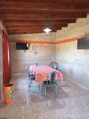 a dining room with a table and chairs at Cabañas Gael in Barrio Parque El Corcovado