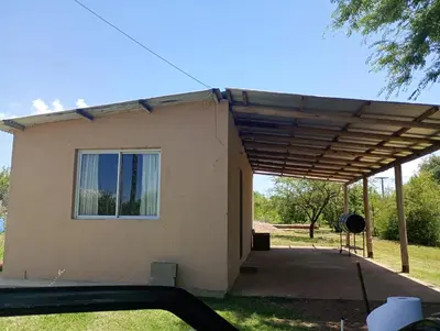 a house with awning over the front of it at Casita feliz in Villa del Dique