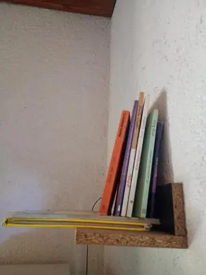 a row of books sitting on a shelf at Casita feliz in Villa del Dique