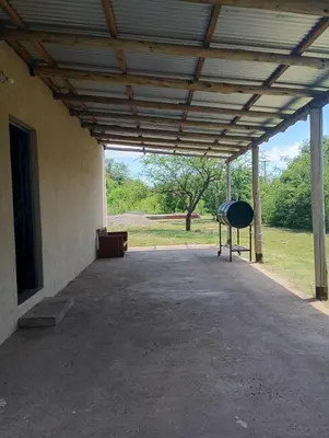 a building with awning and a grill in the middle at Casita feliz in Villa del Dique