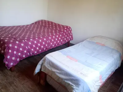 a small room with a bed and acovered mattress at Casita feliz in Villa del Dique