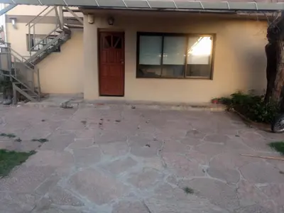 a house with a stone patio in front of a door at El Paraiso 1 in Villa Carlos Paz