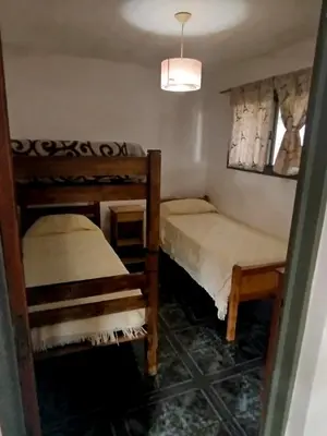 a room with two bunk beds and a window at El Paraiso 1 in Villa Carlos Paz
