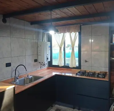 a kitchen with a sink and a window at las huertitas de milele in La Porteña