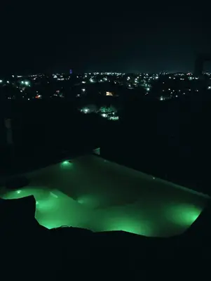 a view of a city at night with green lights at Los Talitas in Villa Parque Siquiman