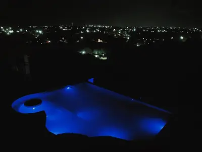 a blue object in the dark with a city at night at Los Talitas in Villa Parque Siquiman