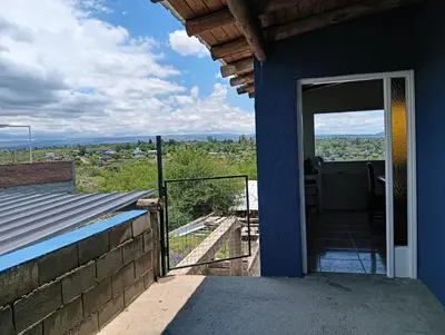 a door to a house with a balcony at Los Talitas in Villa Parque Siquiman