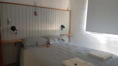 a bedroom with a bed with two towels on it at Casita Salvia in Arroyo de Los Patos