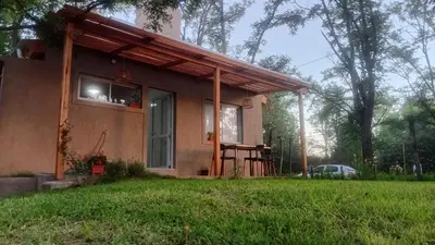 a small house with a porch and a window at Casita Salvia in Arroyo de Los Patos