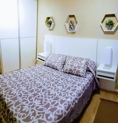 a bedroom with a bed and two night stands at edificio acuario 1 in Villa Carlos Paz