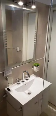 a bathroom with a sink and a mirror at edificio acuario 1 in Villa Carlos Paz