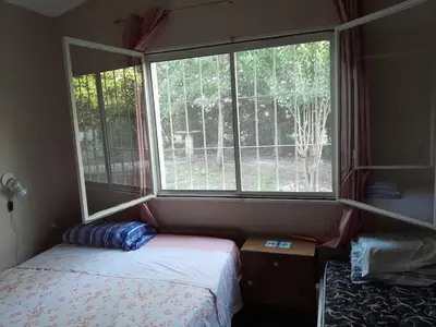 a bedroom with a bed and a large window at Casa Del Mirador in Bialet Massé