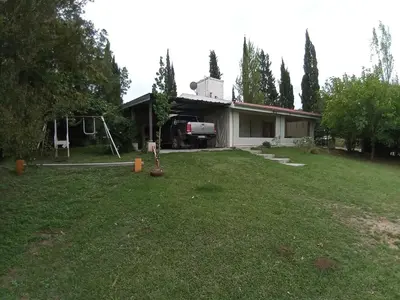 a house with a truck parked in the yard at Casa Del Mirador in Bialet Massé