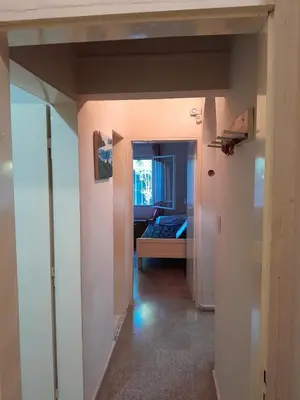 a hallway with a bedroom and a bed in a room at Casa Del Mirador in Bialet Massé