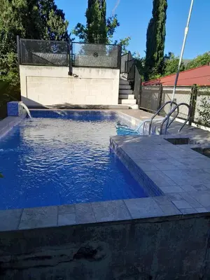 a swimming pool with a bench in the water at Casa Del Mirador in Bialet Massé
