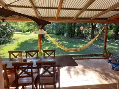 a patio with a table and chairs and a hammock at El descanso in Panaholma