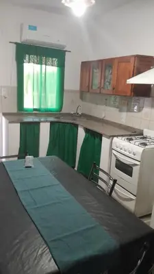 a kitchen with a stove and a green counter top at JM brochero in Villa Cura Brochero