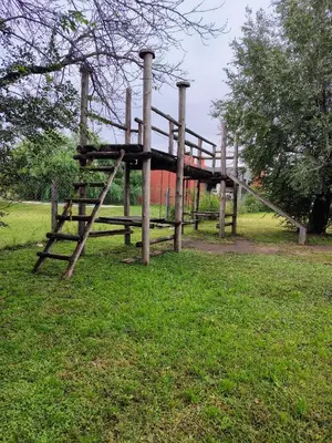 a playground in a park with a slide at Casa y cabañas Sara in Villa Rumipal