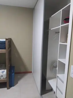 a room with a closet with white shelves at Casa y cabañas Sara in Villa Rumipal