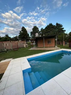 a swimming pool in front of a house at Las tres lunas 2 in Villa Anizacate