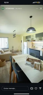 a kitchen and living room with a table and chairs at En Gracia, tu casa de Montaña in Alta Gracia