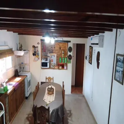 a kitchen with a table and a kitchen with a refrigerator at Claro de Luna in Los Reartes