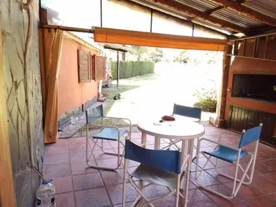 a patio with a table and chairs on a patio at Claro de Luna in Los Reartes