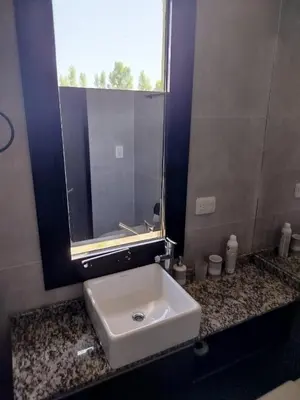 a bathroom with a white sink and a window at Casa a estrenar En Trapiche - Pileta privada in Trapiche