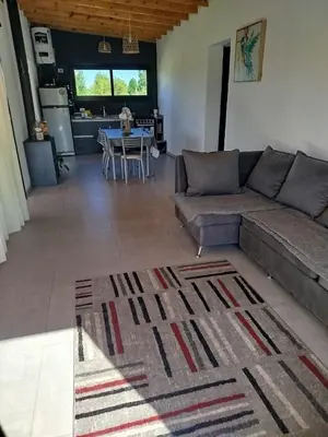 a living room with a couch and a table at Casa a estrenar En Trapiche - Pileta privada in Trapiche