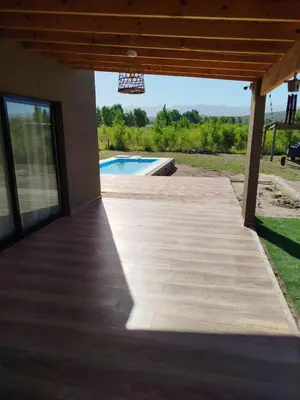 a patio with a pool and a basketball hoop at Casa a estrenar En Trapiche - Pileta privada in Trapiche
