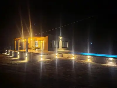 a house lit up at night with lights at Casa a estrenar En Trapiche - Pileta privada in Trapiche