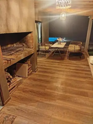 a room with a table and chairs and a fireplace at Casa a estrenar En Trapiche - Pileta privada in Trapiche